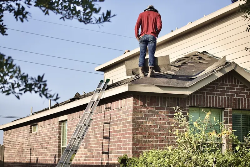 Professional roofer working on a residential roof in Fort Shawnee